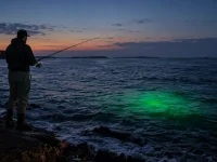 Shore fishing at night with a green underwater fish attractor light